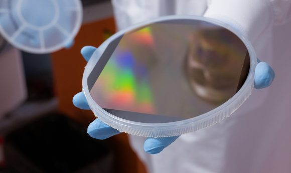 a researcher holding a silica plate
